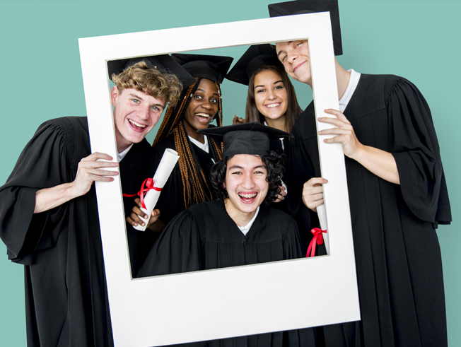Young group of teens in graduation cap and gown